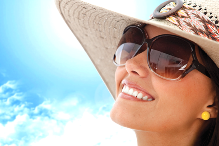 A happy, smiling woman with the invisalign logo next to her