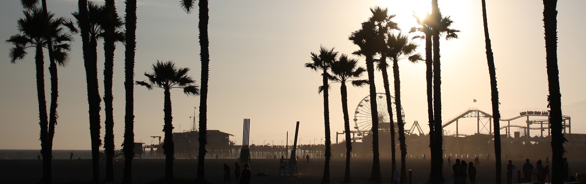 View of a silhouetted Santa Monica pier from a distance