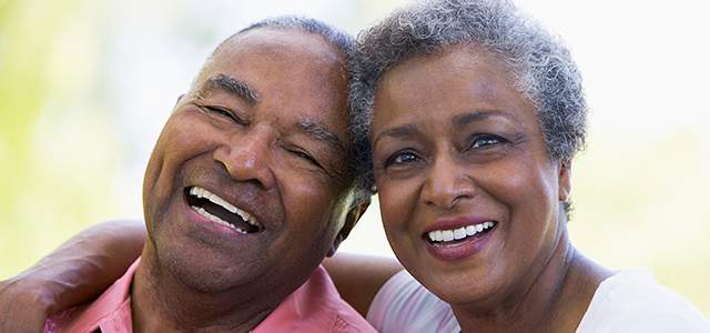 Smiling elderly couple embracing