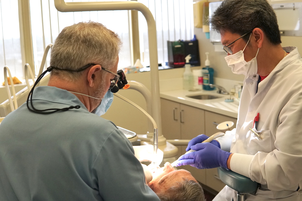 Dentists caring for patient