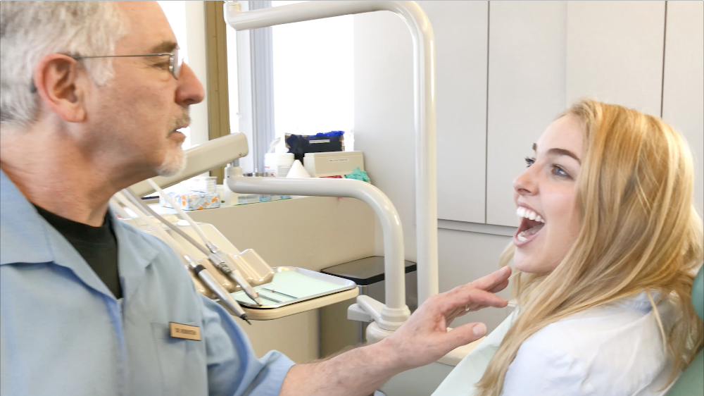 Dentist checking patient's smile